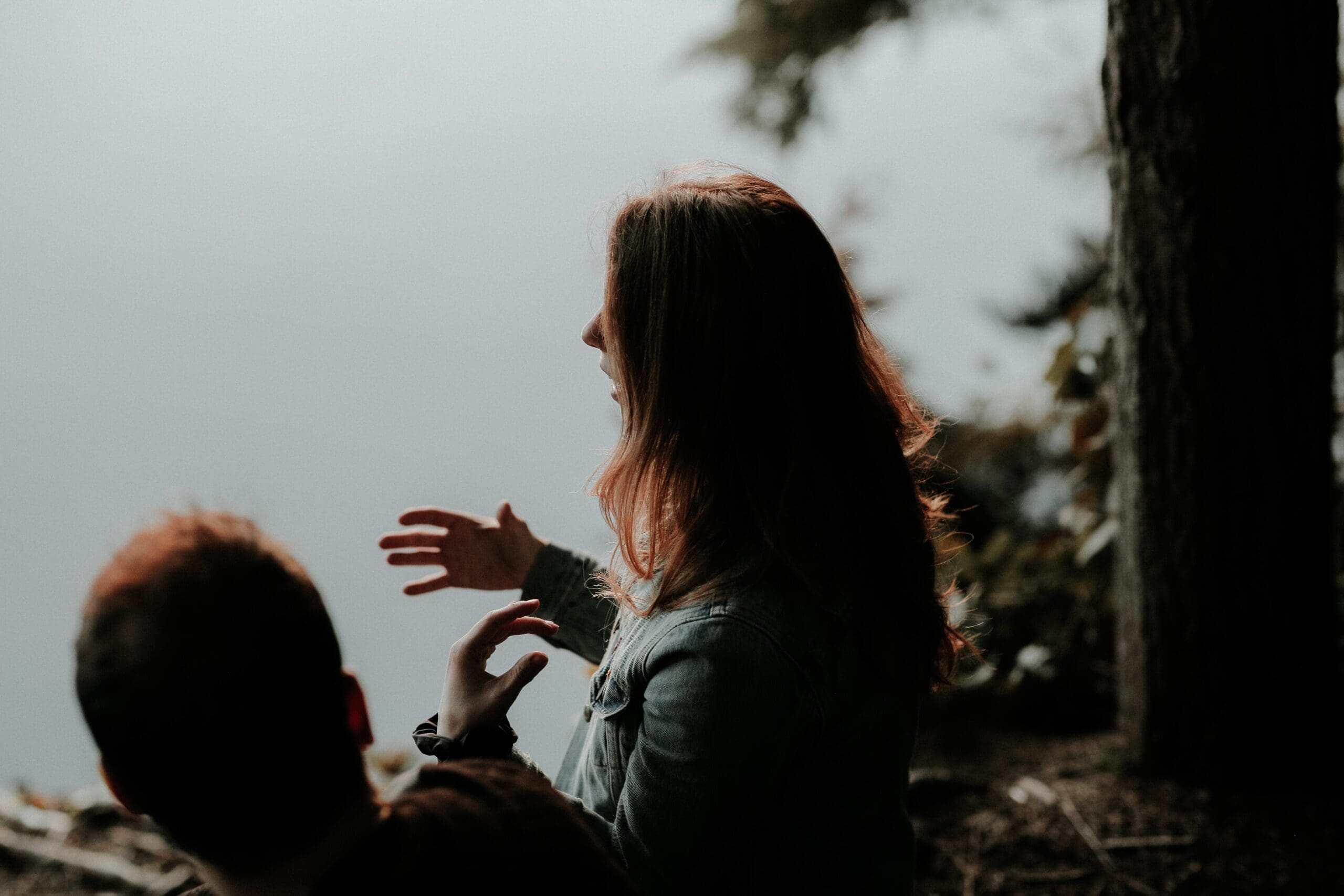 a woman sits with a friend and explains her lived experiences to them